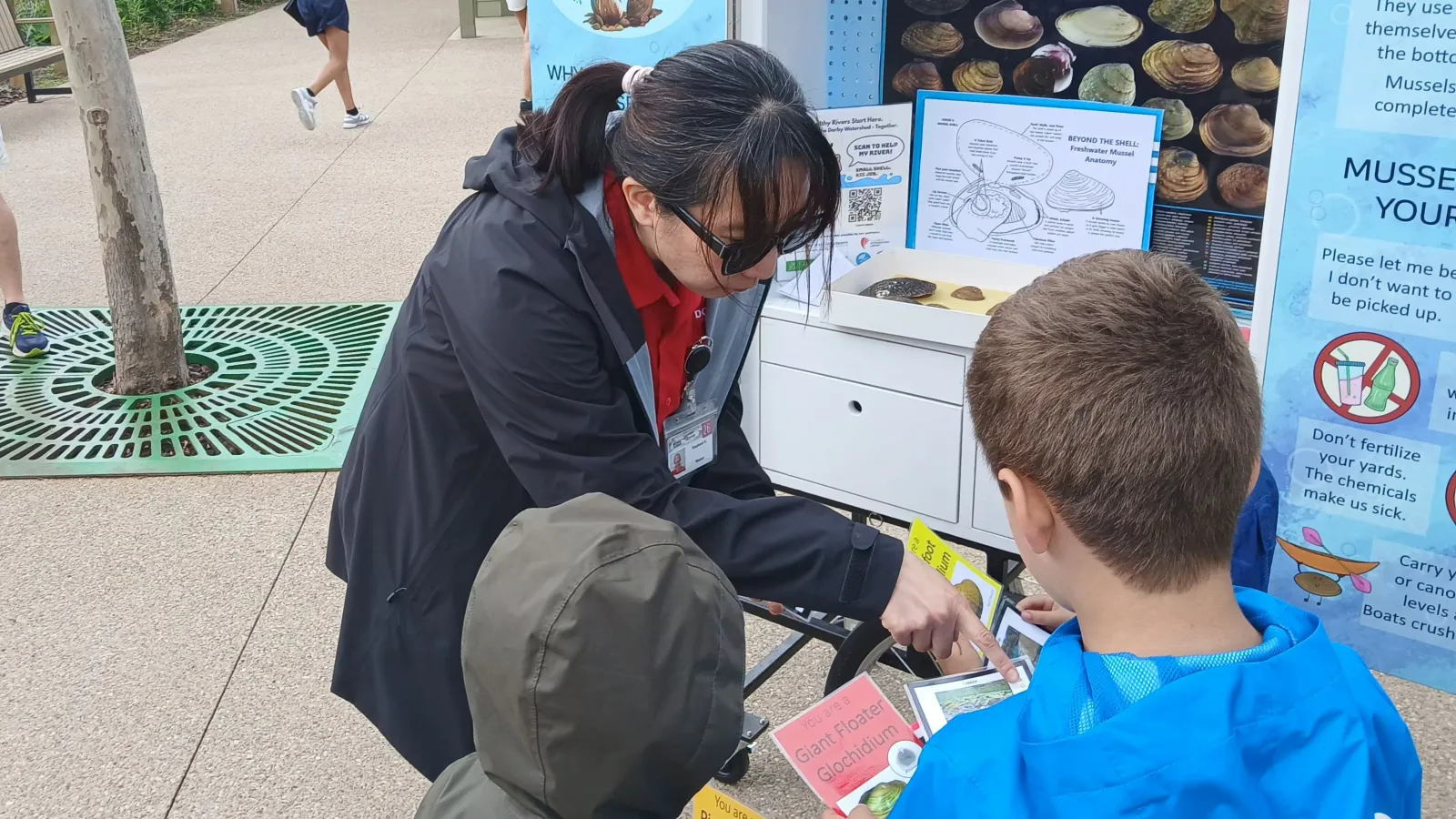 Display of information on freshwater mussels being looked at by an adult and two children