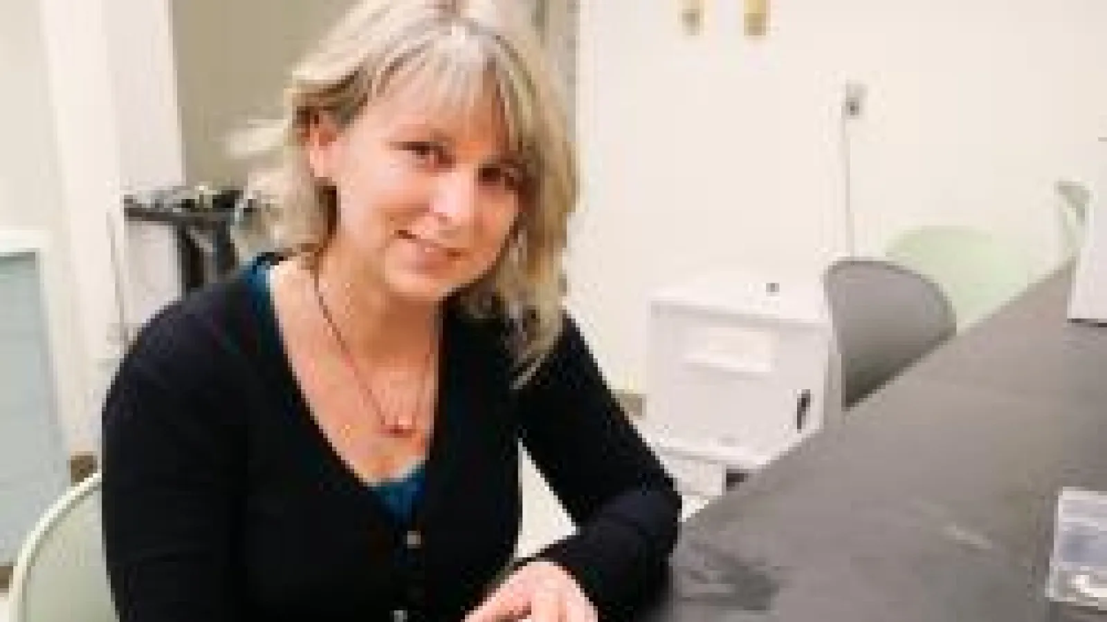 Rachelle Adams sitting at desk