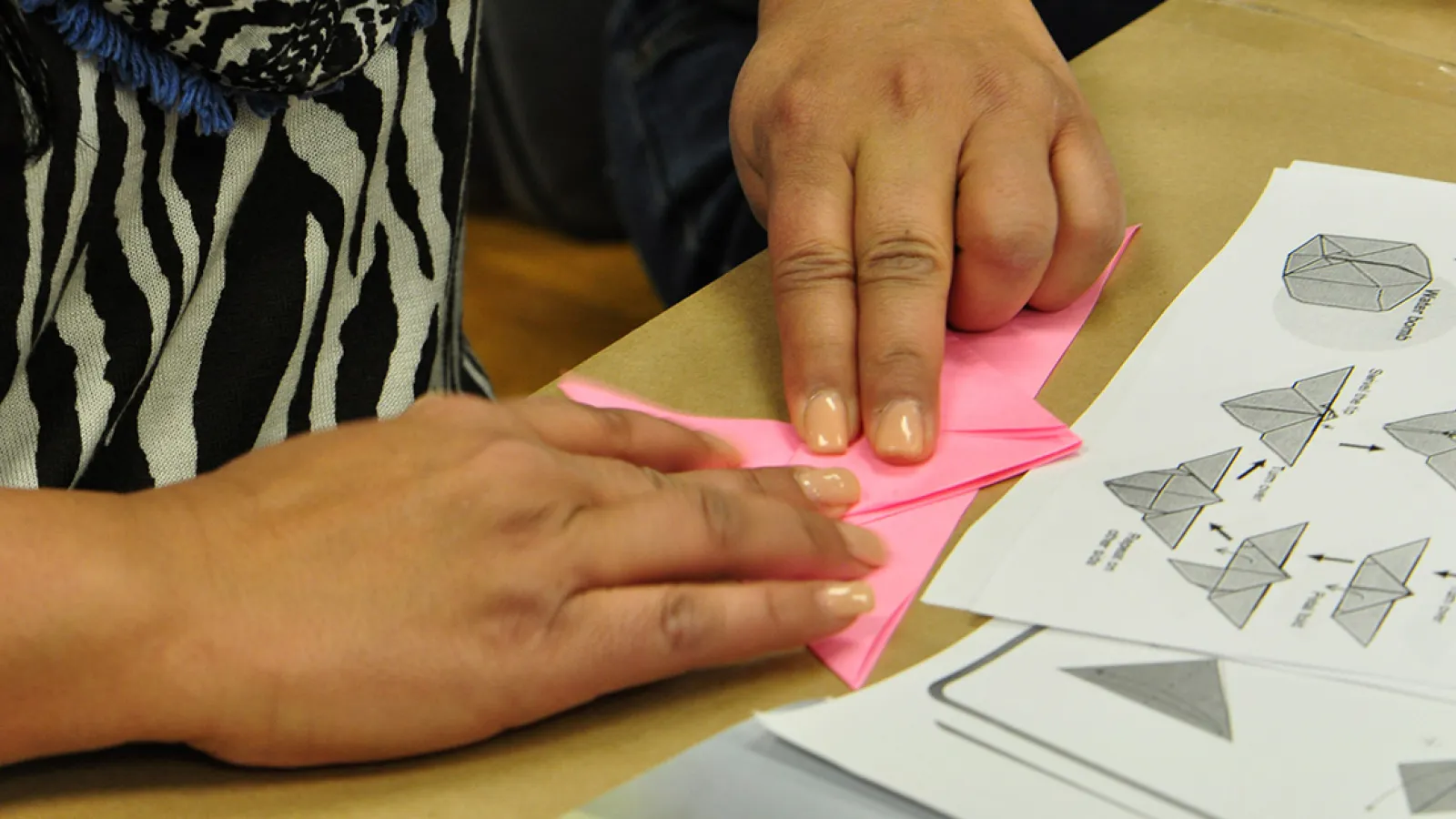 Visitor learns how to make origami butterfly