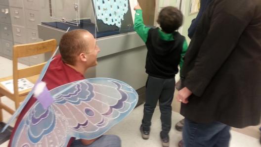Entomology graduate student volunteer interacting with visitors durng the Museum Open House