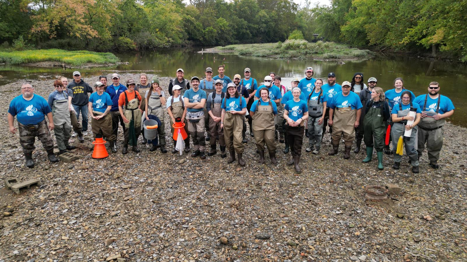 Participants in the 2023 FW Mussel Workshop standing outside in the Olentangy River in Columbus