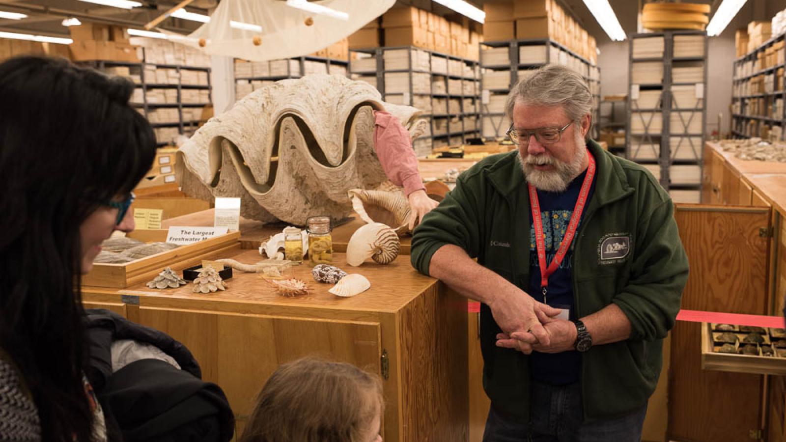 a man stands next to a giant 3 foot wide clam